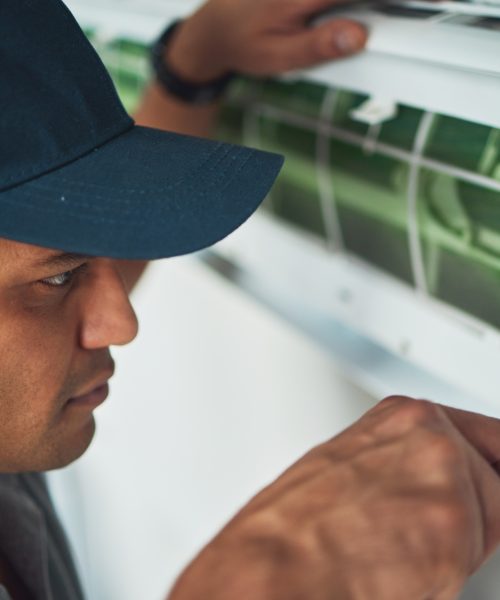 Face, hand and a man for aircon repair or maintenance in an office for circulation or central heati